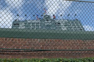 Scoreboard beyond brick wall