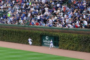 Ian Happ and Pete Crow-Armstrong try to catch the ball unsuccessfully 