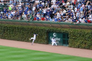 Ian Happ and Pete Crow-Armstrong try to catch the ball