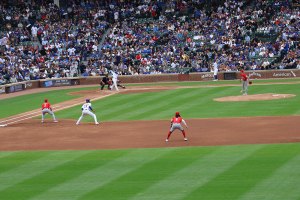 Cubs man on first leads off as pitch is delivered