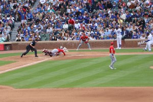 Reds catcher attempts to tag Nico Hoerner who scores safely