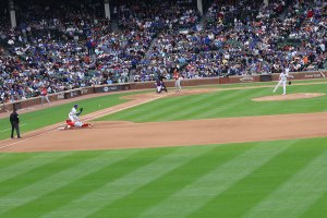 Pitcher throws ball to Michale Bush who prepares to catch it on a pickoff attempt