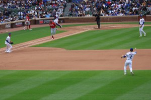 Nico Hoerner throws to first base for the out