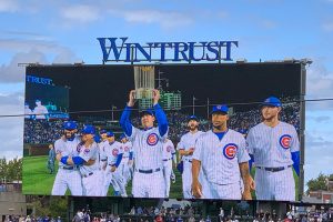 Wintrust video board with 2016 Cubs carrying trophy