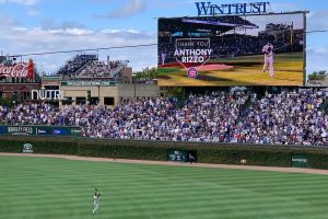 Anthony Rizzo with arms up in air acknowledging fans