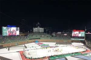 Action on ice with scoreboard in background