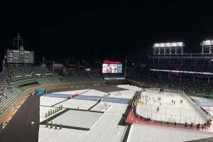 Scoreboard  and outfield beyond ice rink