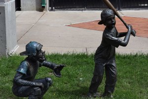 Statue of kids playing baseball