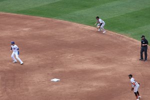 Cubs player on second base with umpire and fielders in background