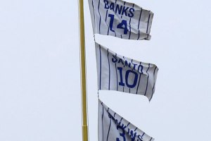 Left field foul pole with flags of retired Cubs