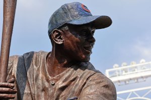 Ernie Banks statue with lights in background