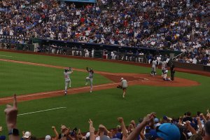  Closeup of third base coach high fives batter as he is about to score