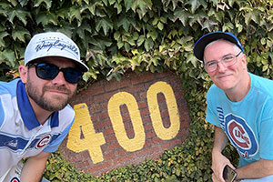 Pat and Tommy on Wrigley Field in front of the 400 sign.